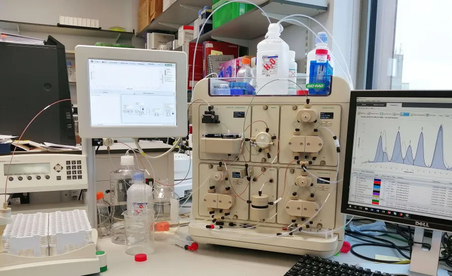 View of a bench with protein analysis equipment and computer screen showing results