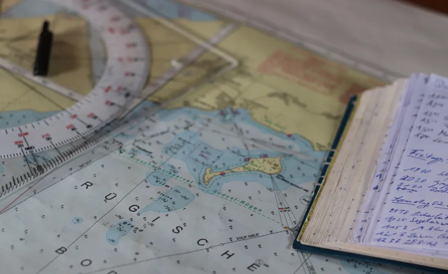 Nautical chart and a notebook on a table