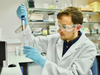 A medical researcher looks at a sample in a laboratory