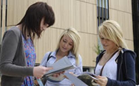 Students looking at University events schedule.