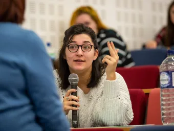 Student talking with microphone during a lecture.