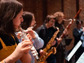 A group of young musicians playing a range of brass and wind instruments