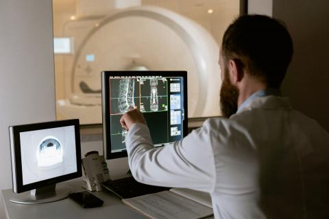 Healthcare professional monitoring an MRI scan and viewing the results