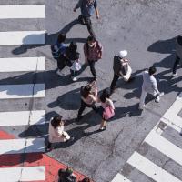 People crossing a busy pedestrian crossing