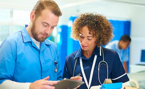 Qualified male nurse talking to matron