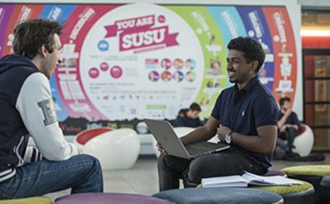 Two students talking together in Student Union