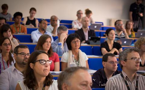 Delegates listening to podcast conference