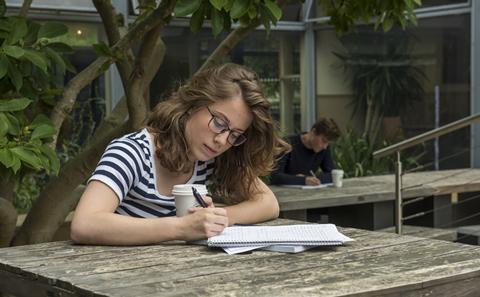 Student writing notes