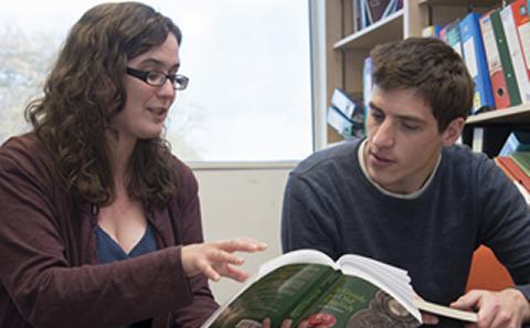 2 students discussing paperwork