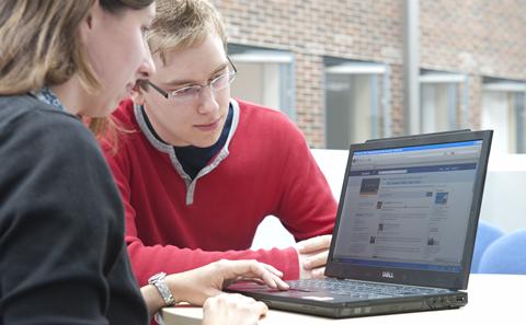 Students looking at documents on a computer