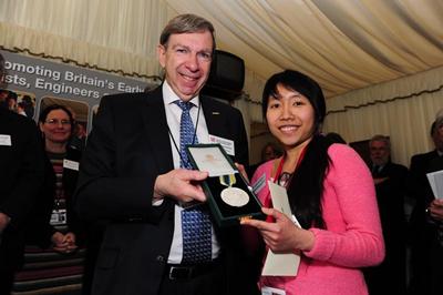 STEM for Britain poster prize winner ThaoNguyen Nguyen receiving the Roscoe Medal.