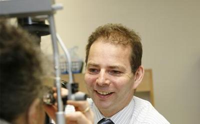 Prof Andrew Lotery with a patient