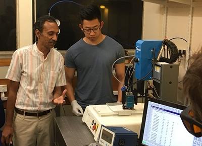 Dr Collin Sones and Dr Peijun He laser printing wells in paper