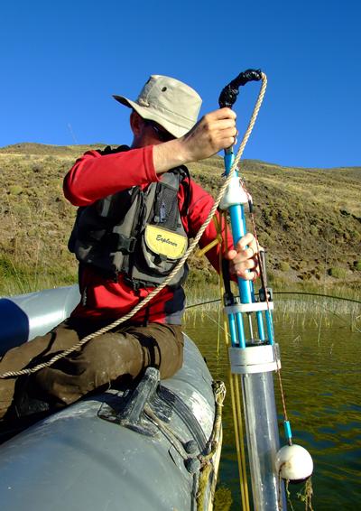 A geographer uses a specialist tool in a body of water