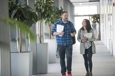 2 students walking down corridor