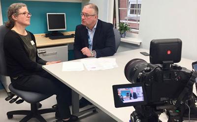 Camera unit filming two academics