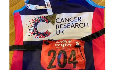 Liz's triathlon medal and race number