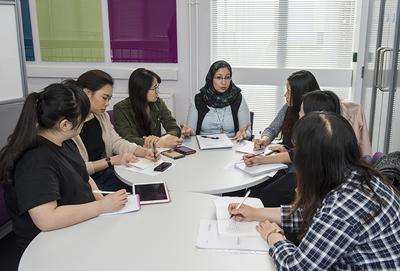 Students studying round desk