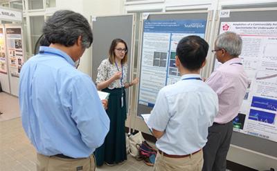 Jenny presenting her poster to members of the judging panel