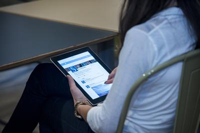 Woman sat down using ipad