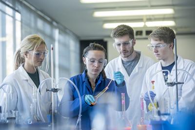 Adam works with a tutor in the lab
