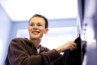 Student sat at a table smiling