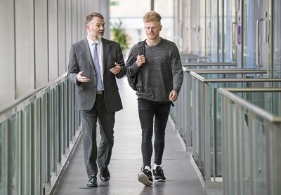 Student and tutor walking and talking