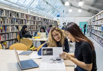 Students reading course brochures