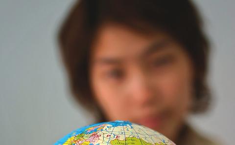 Women holding globe