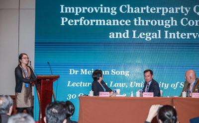 Dr Song on stage at conference