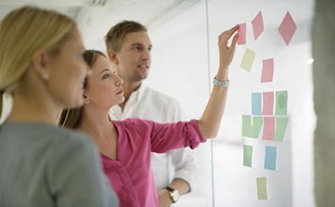 People looking at work boards
