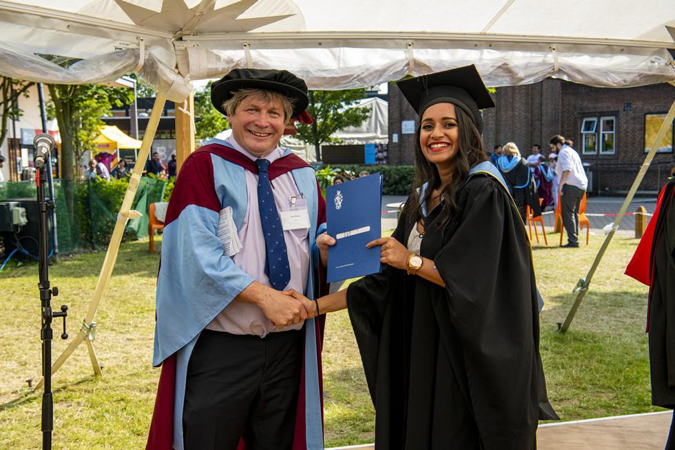 Student receiving graduation certificate  