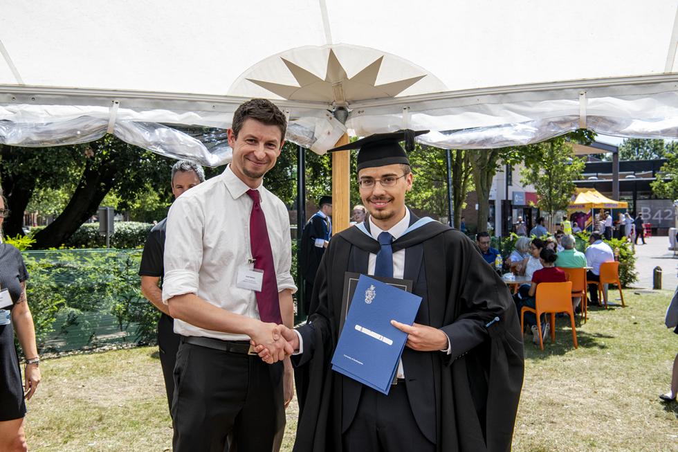 Student receiving graduation certificate  