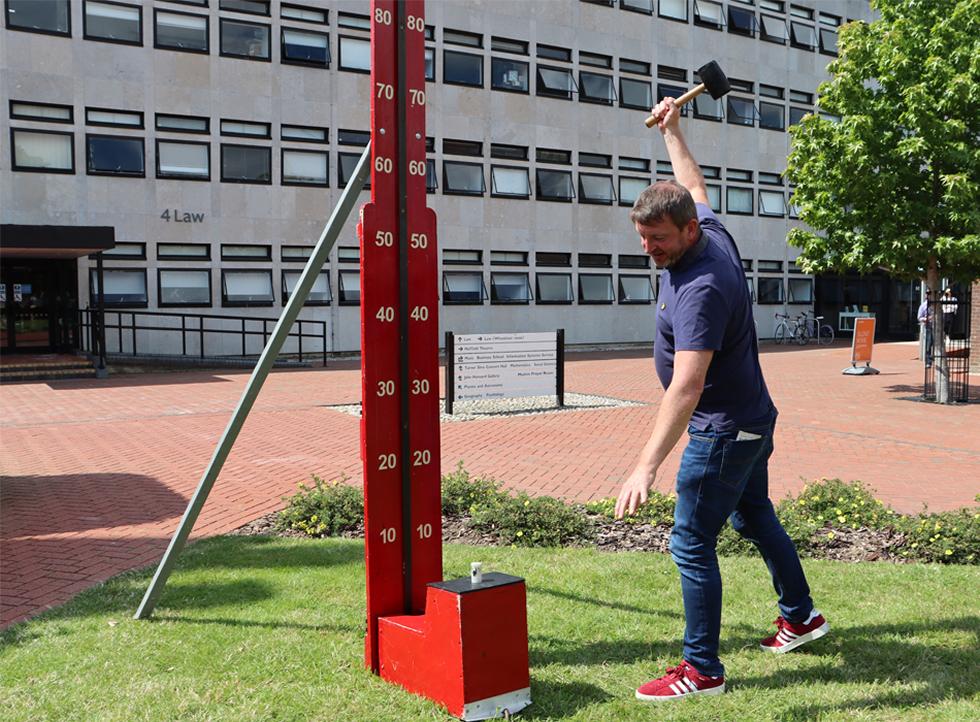 Staff having a go on the strength test