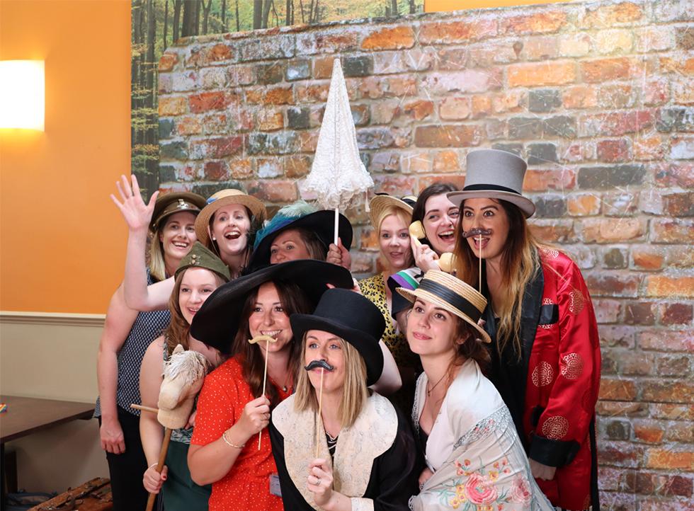 Staff posing with fancy dress for a fun photo