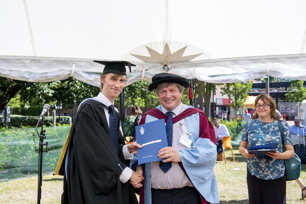 Student receiving graduation certificate  