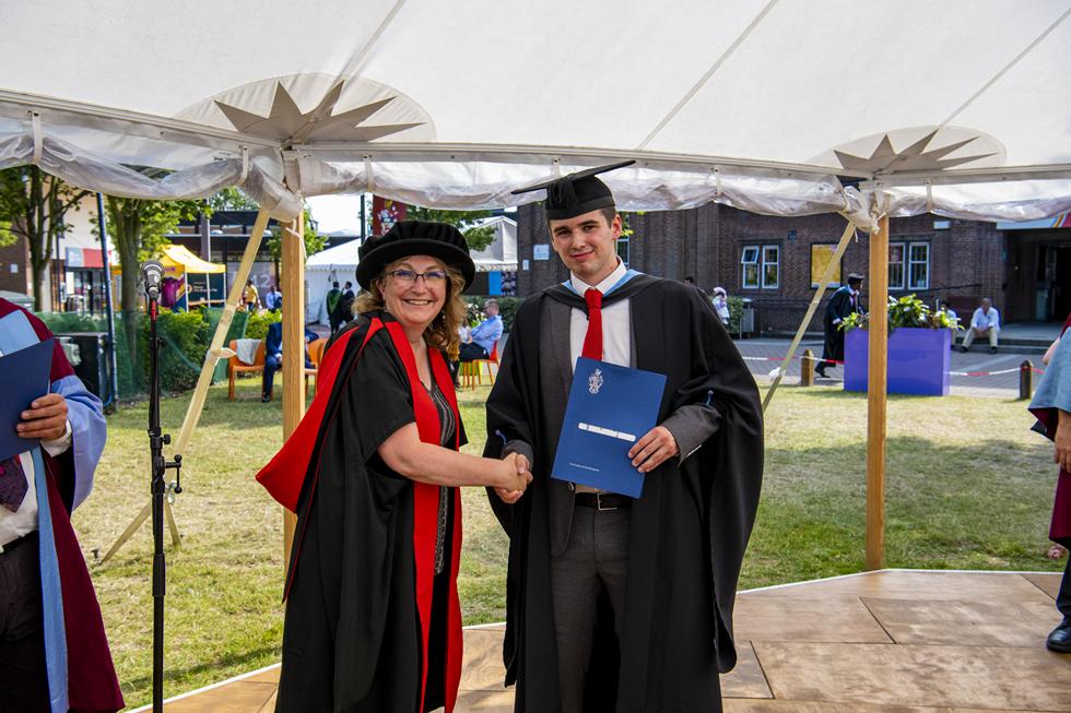 Student receiving graduation certificate  