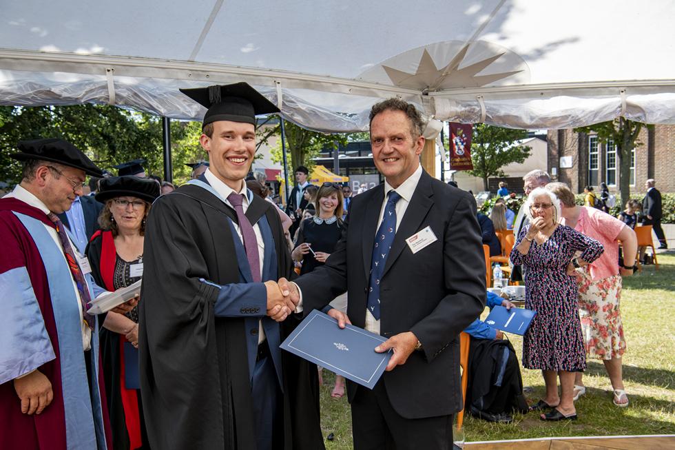 Student receiving graduation certificate  