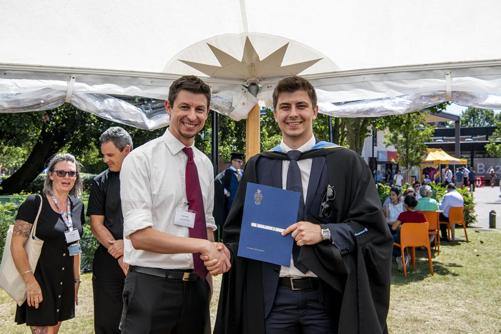 Student receiving graduation certificate  