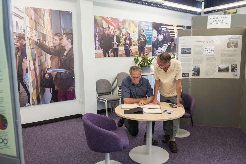 Research showcase and guests signing guest book