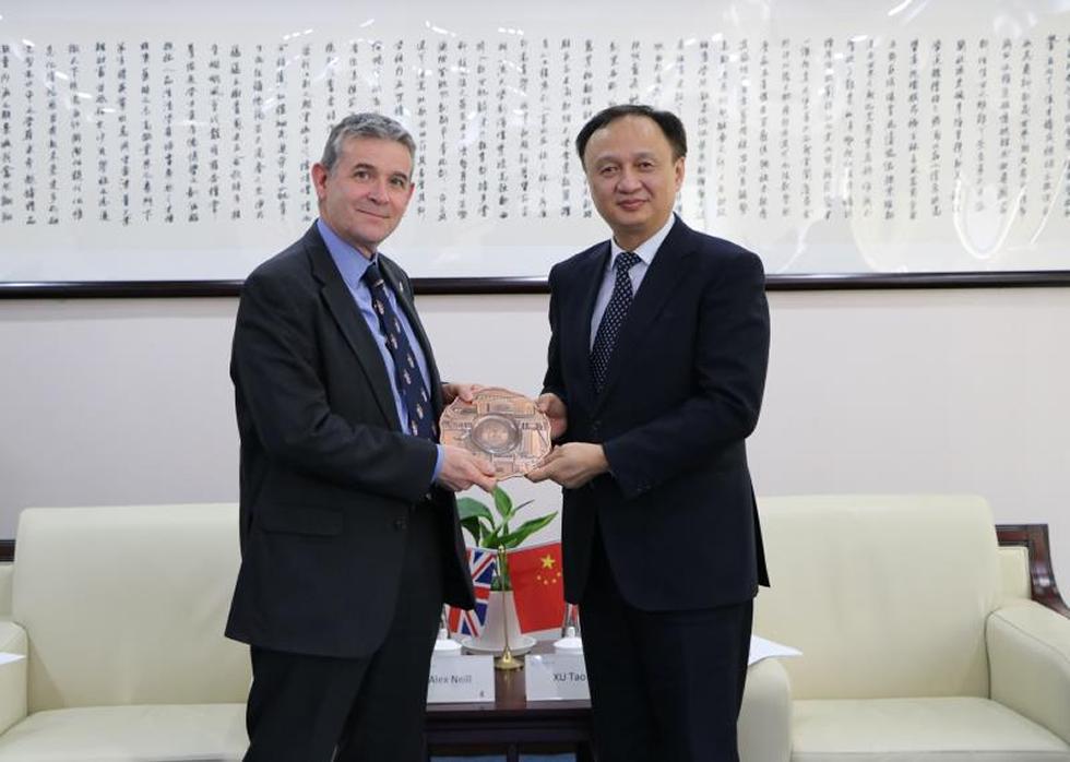 Alex Neill posing for commemorative photo with Xu Tao