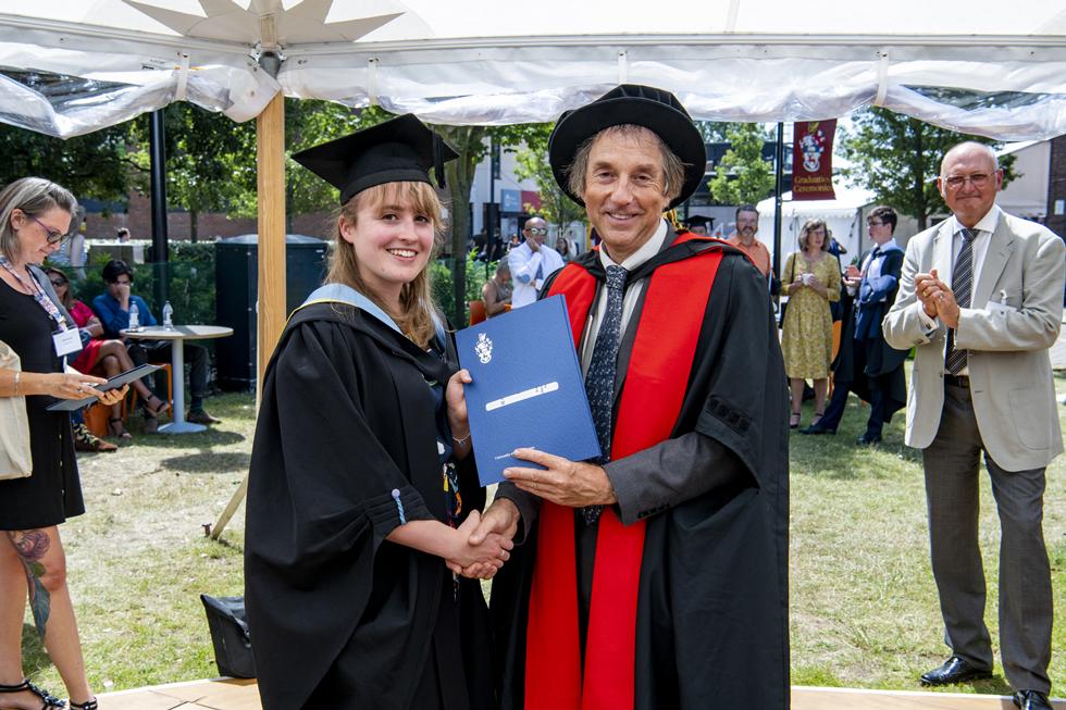 Student receiving graduation certificate  