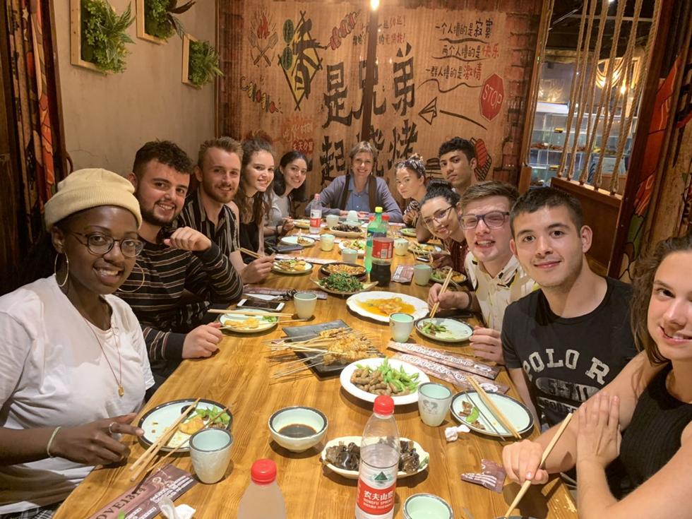 Students having a delicious authentic meal with Prof Traute Meyer