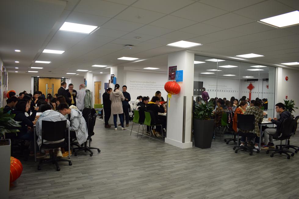 Students and staff eating dinner together