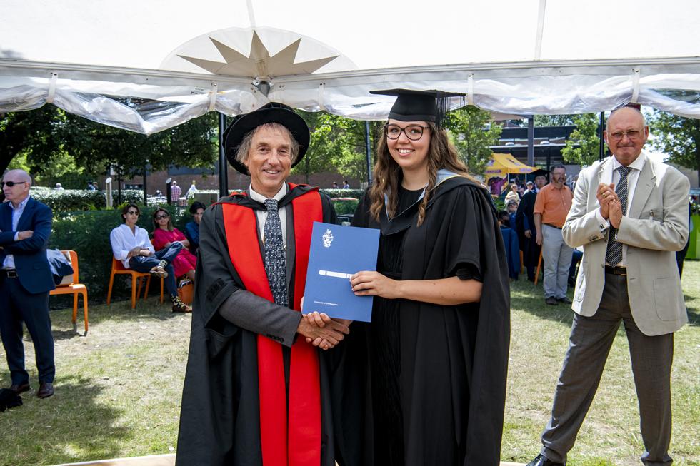 Student receiving graduation certificate  