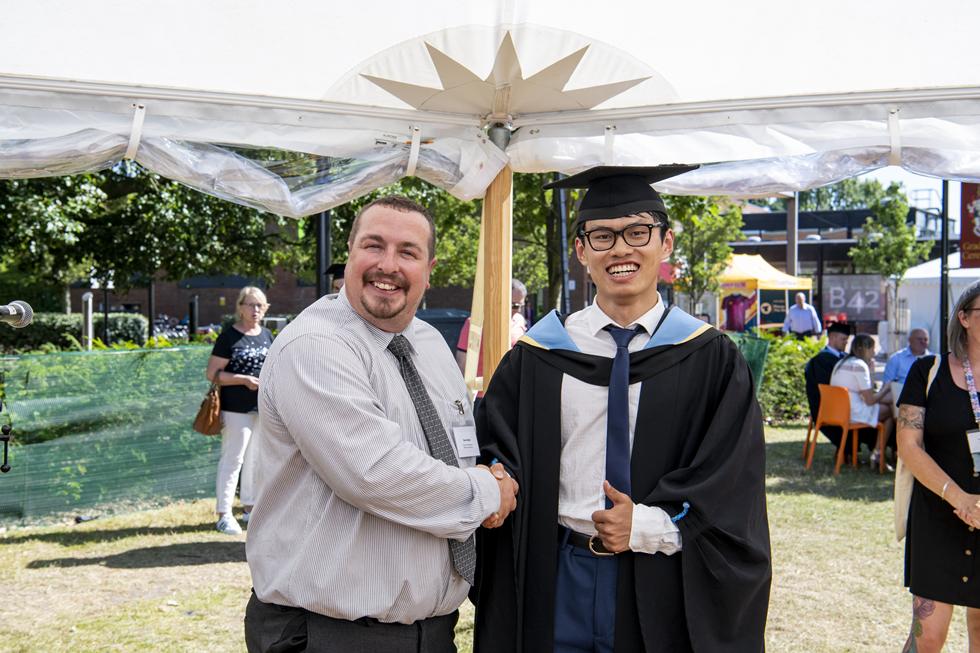 Student receiving graduation certificate  