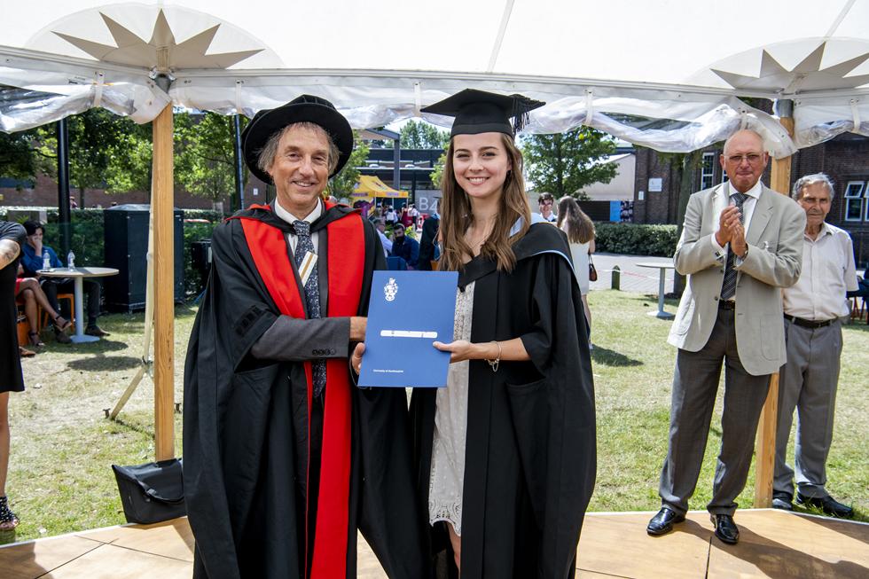 Student receiving graduation certificate  