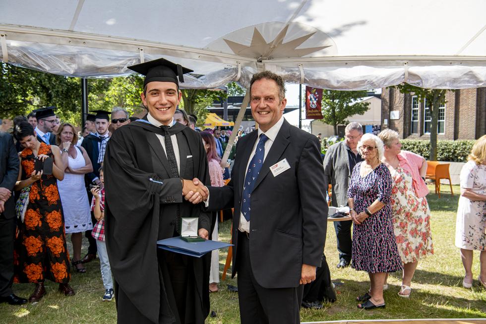 Student receiving graduation certificate  