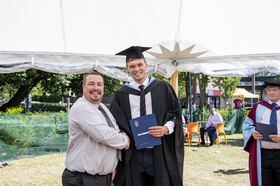 Student receiving graduation certificate  