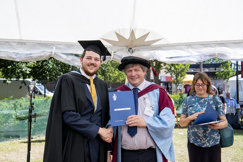 Student receiving graduation certificate  